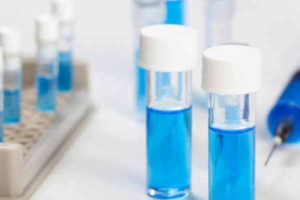 Vials and syringe of blue liquide.
