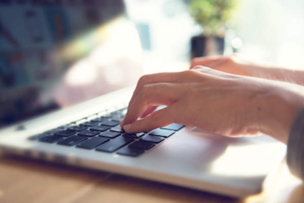 Woman working on laptop.