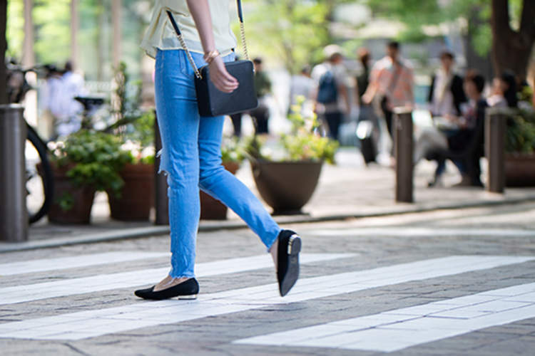 Woman crossing a city street.