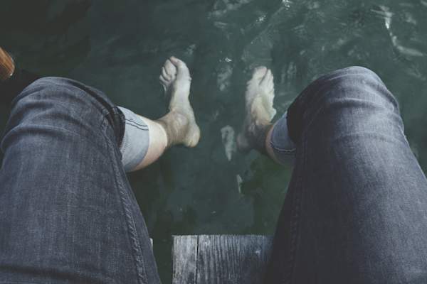 man with feet in water