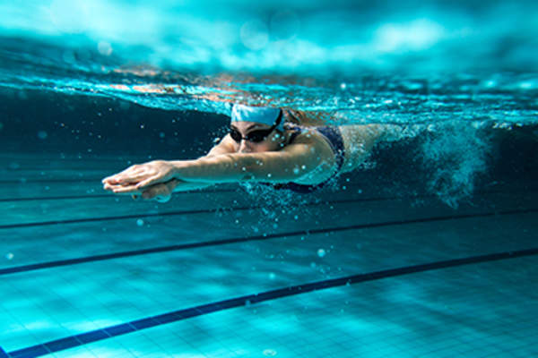 Woman swimming in a pool.