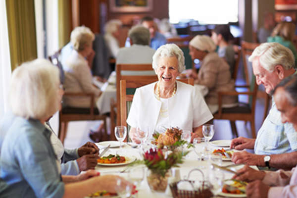 Seniors in nursing home dining room.