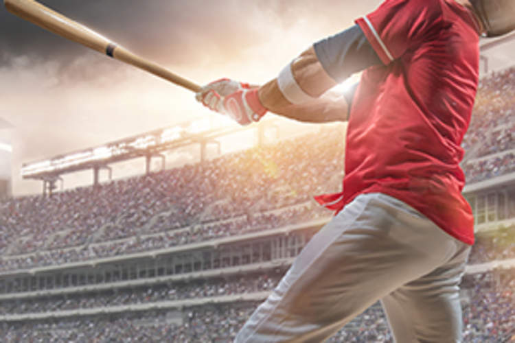 Baseball Player Hitting Ball During Baseball Game In Outdoor Stadium