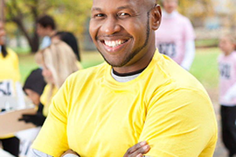 Man smiling as he stands at volunteer activity.