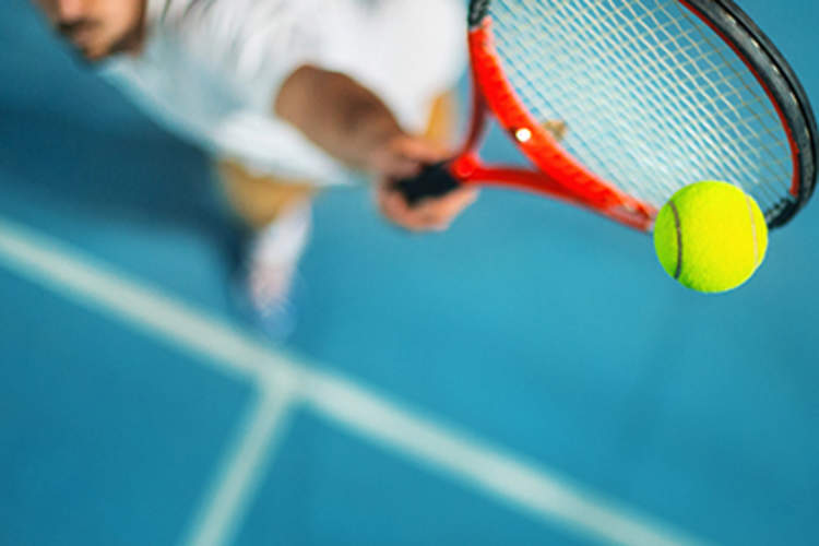 Man playing tennis.