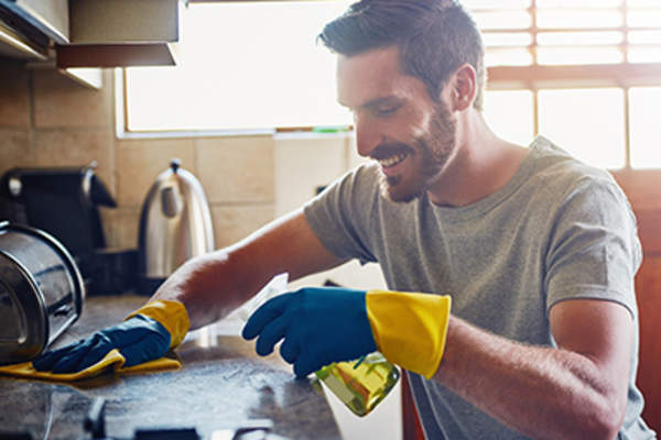 Man wearing gloves while cleaning.