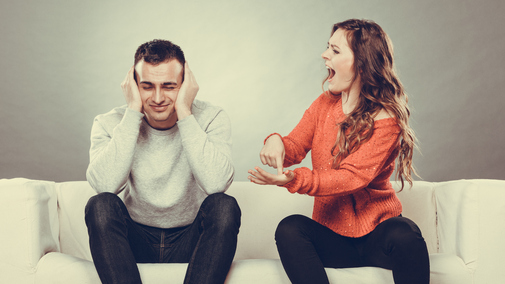 Angry fury woman screaming man closes his ears.