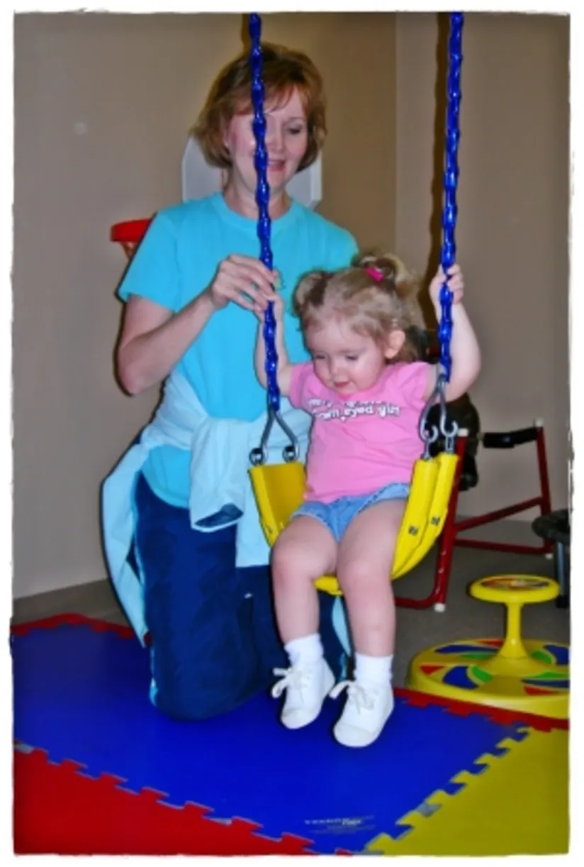 Ella learning balance with her therapist
