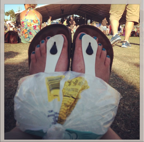 Britt's kettle corn bag of ice on her knees at a music festival