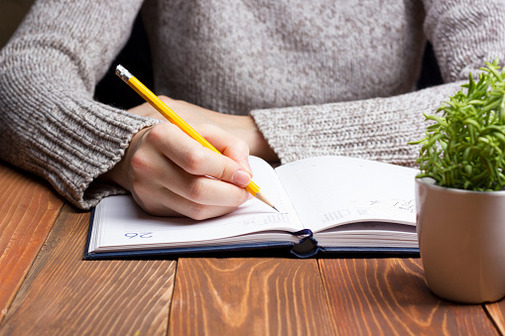 woman writing in diary