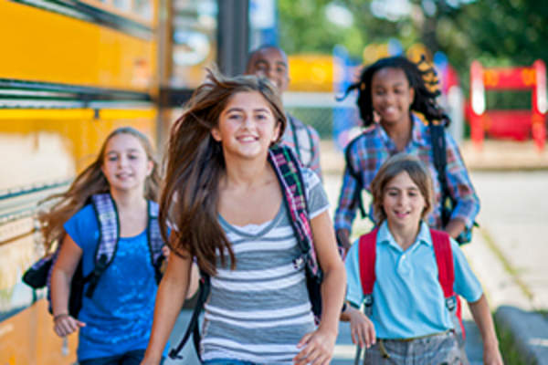 kids walking from school bus image
