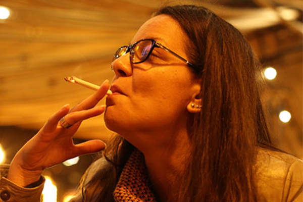 Woman smoking in a bar.