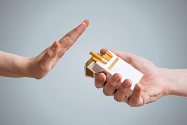 Quitting smoking concept. Hand is refusing cigarette offer