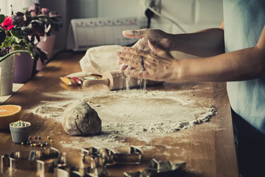 Woman making gingerbread cookies.