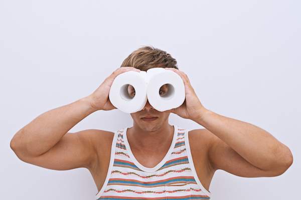 Looking through toilet paper binoculars.