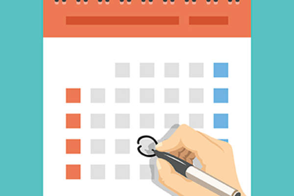 Woman circling date on calendar.