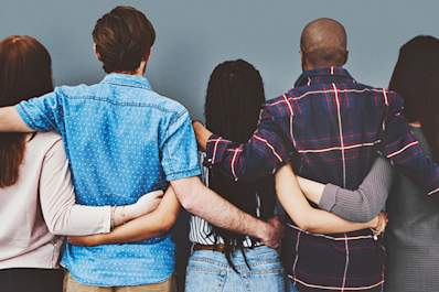 Group of people with arms around each other's waists in support.