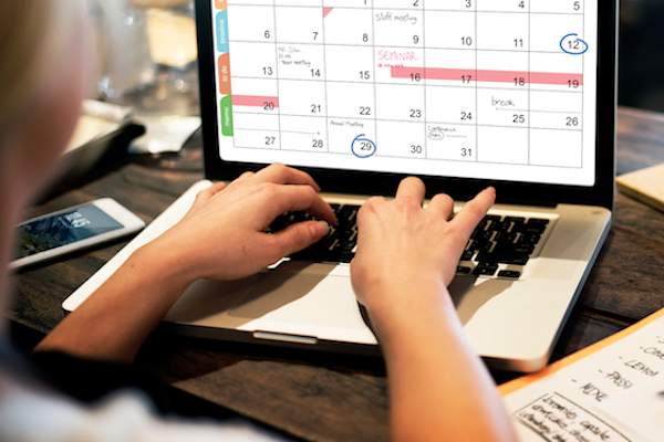 Woman working on calendar online.