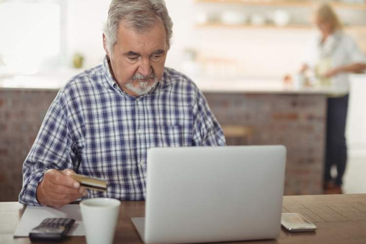 Man shopping online with credit card.