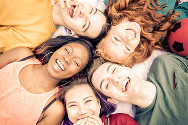 Group of young adult friends laughing.