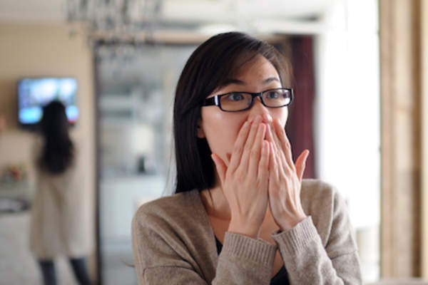 Woman watching natural disaster on news.