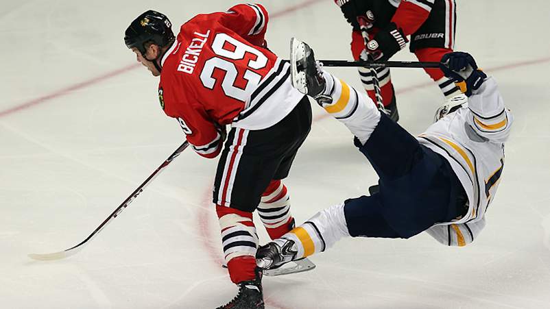 Cody Hodgson #19 of the Buffalo Sabres goes flying in the air after colliding with Bryan Bickell #29 of the Chicago Blackhawks