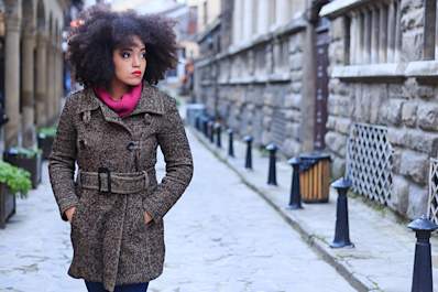 Stylish woman wearing a winter coat outdoors.