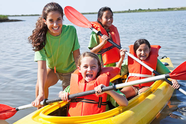 girls in kayaks at summer camp image