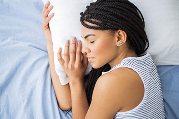 Teenage girl sleeping in bed.