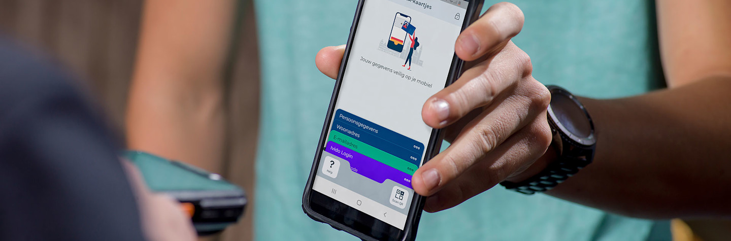 Close-up of smartphone in a person's hand showing the IRMA app.