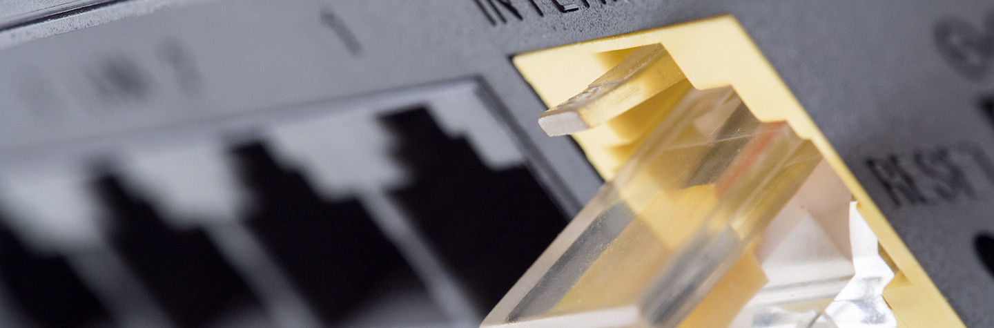 Yellow network cable connecting to the internet slot