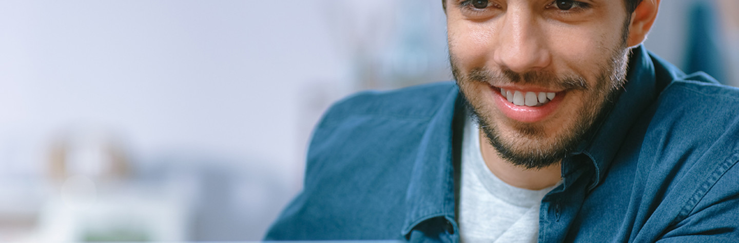 Portrait of a young man using his laptop