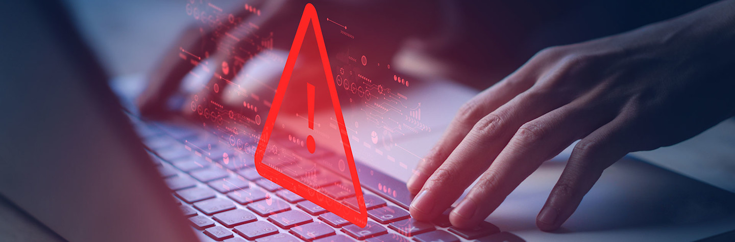 Red warning sign above the keyboard of a laptop