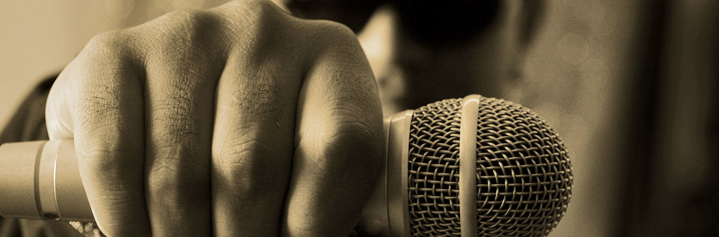 Close-up of a rapper's hand holding a microphone