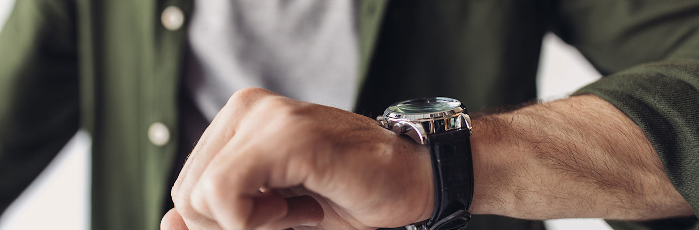 Man looks at a watch on his wrist