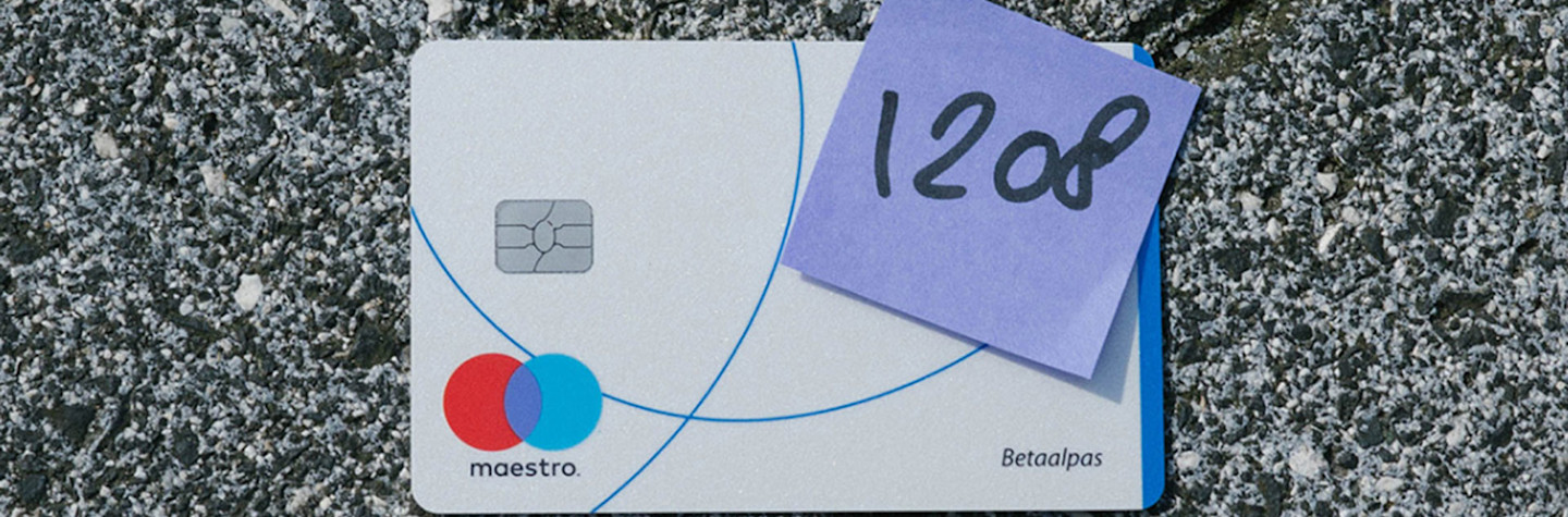 Debit card that is on the street, with a note with the pin code stuck on the card.