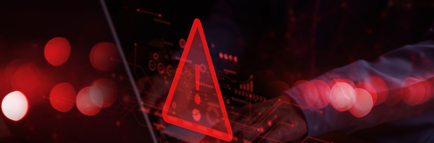 Red warning symbol above a laptop