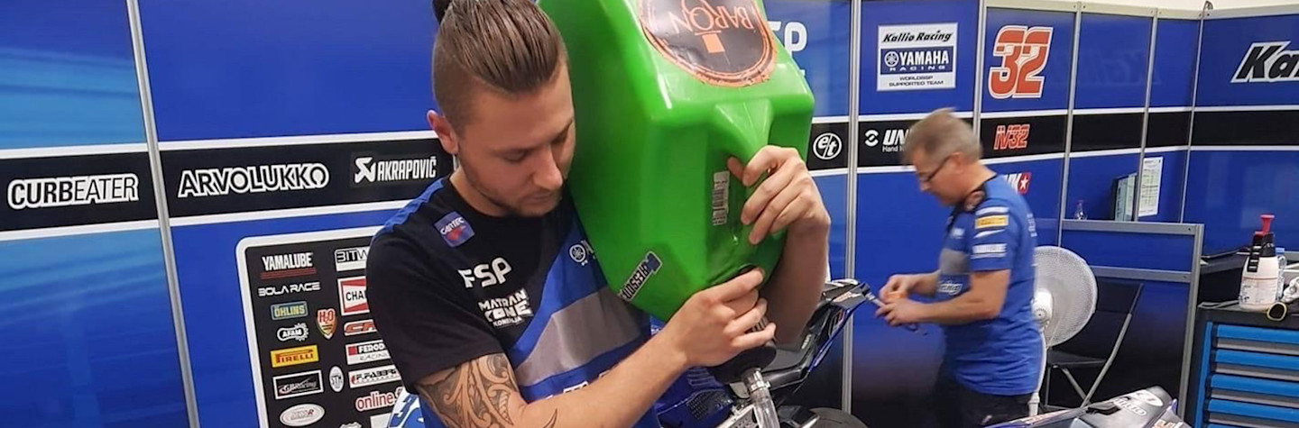 Jarie Scheepstra, owner of Volare Motoren, fills a tank of a motorcycle with gasoline.
