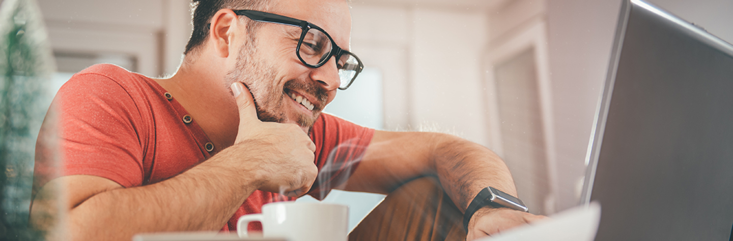 Man is happy behind his laptop