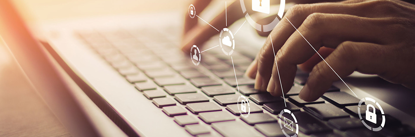 Hands operating a keyboard above which virtual security icons are visible