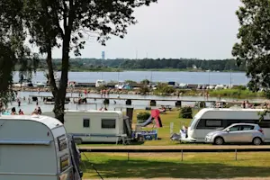 Enjoy seaside camping with sea views and easy parking on our 10×10 m grassy pitches. Trummenäs Camping offers modern facilities, including 130 pitches with electrical hook-ups, playgrounds, and newly constructed boules courts. Experience coastal living at its finest!