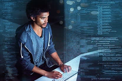 Man Coding A man coding and code surrounding him
