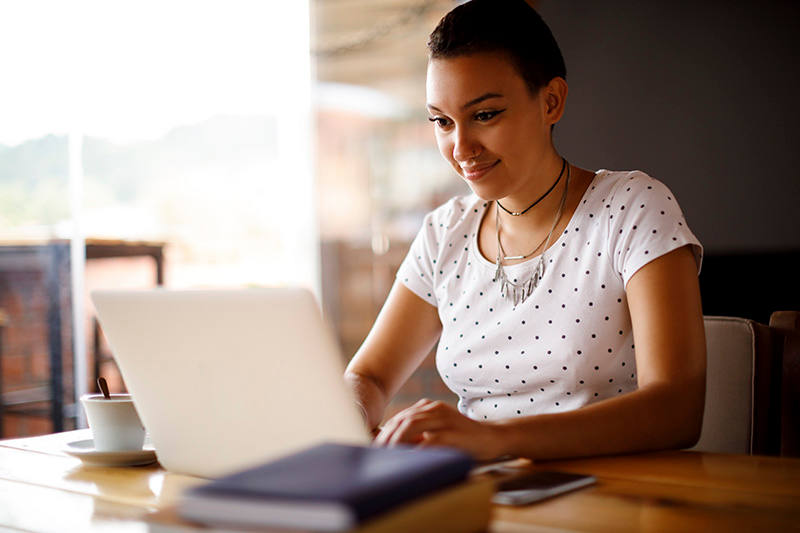 Woman working remotely or taking an online coding bootcamp