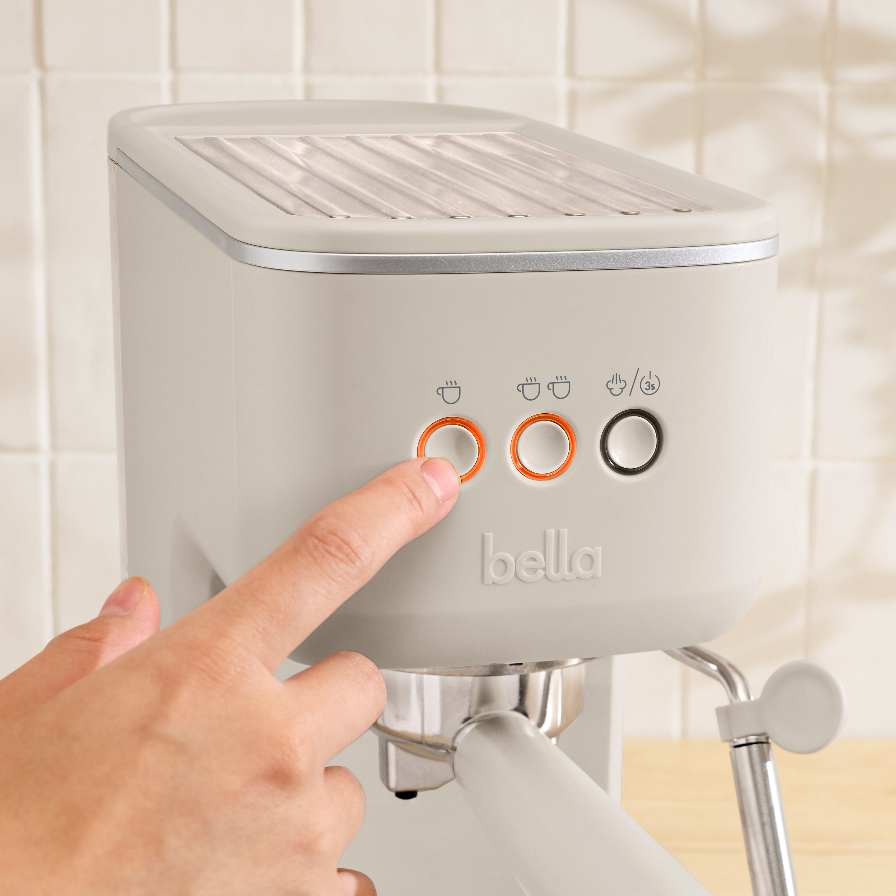 Close up of espresso machine with finger pressing button.