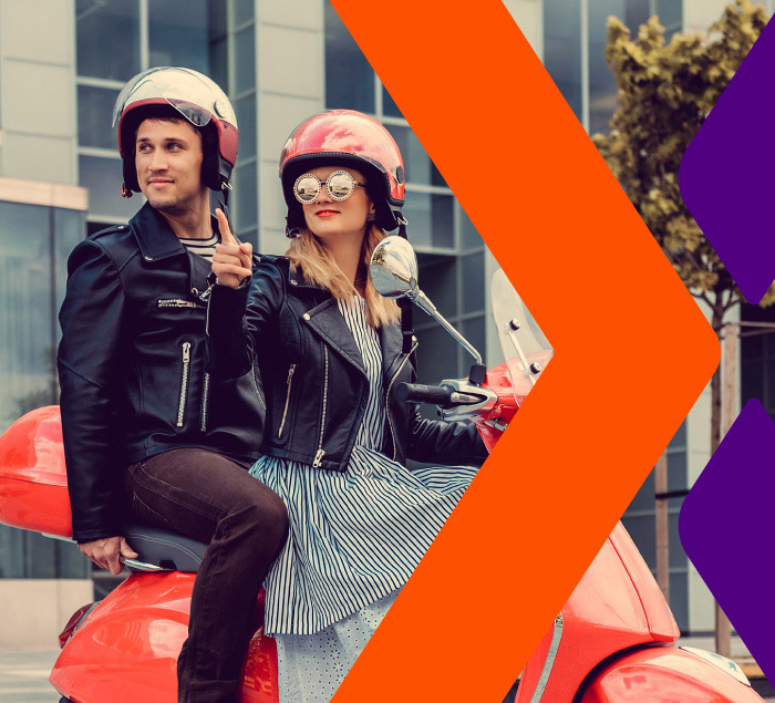 Hombre y mujer con casco sobre una moto