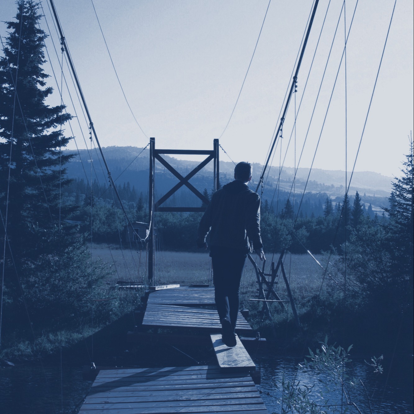 Boy walking on bridge