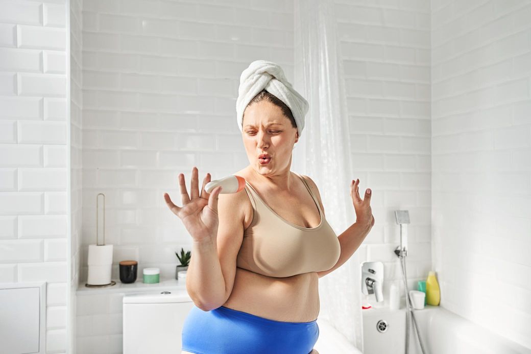 Frau tanzt im Badezimmer