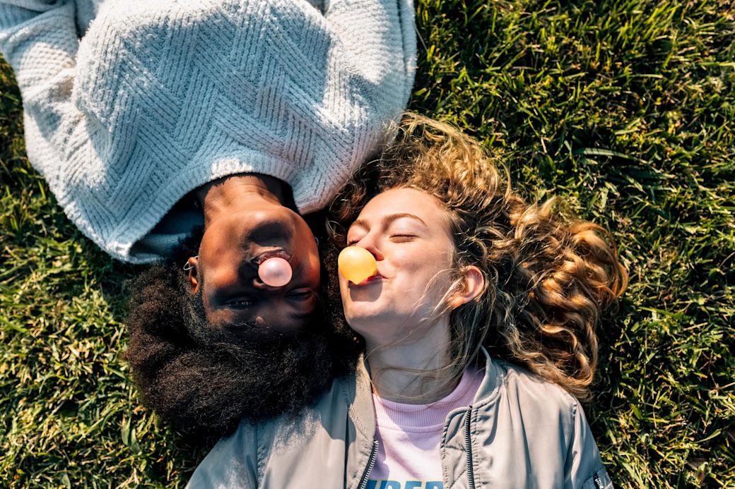 Gute Energie plus sorglos Service für Strom und Gas Happy Frauen mit Kaugummi auf einer Wiese