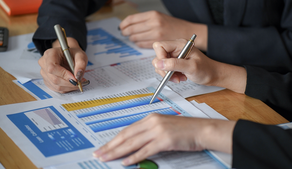 close-up-shot-of-accountants-are-reviewing-company-DHHDUTR