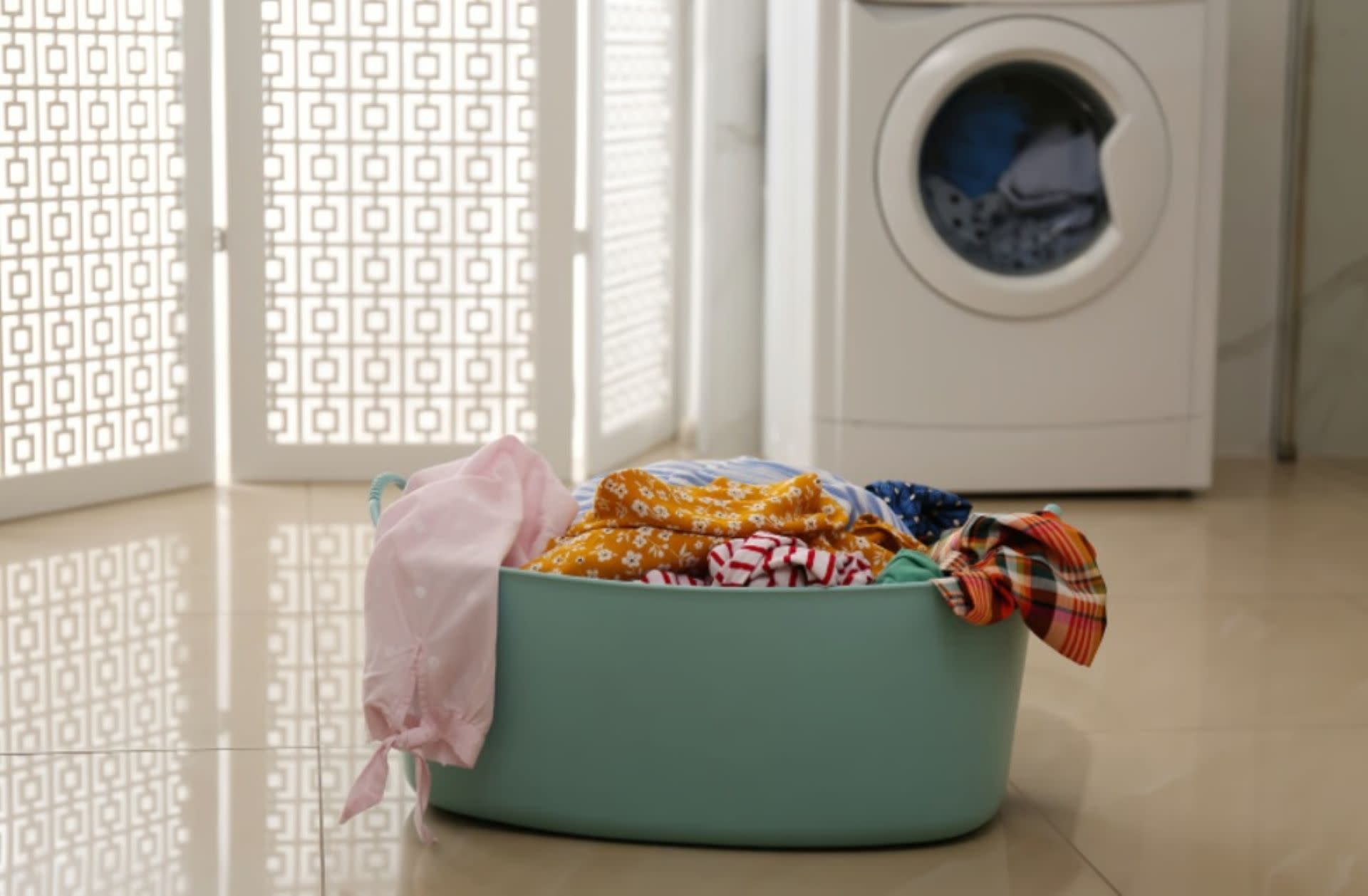 Clothes kept in basket near front load washing machine